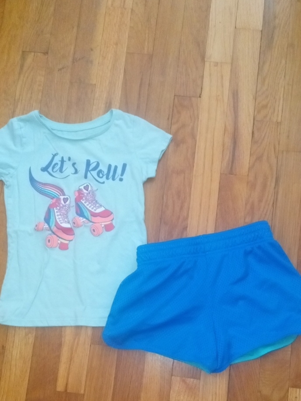 girl med graphic tee and blue mesh shorts